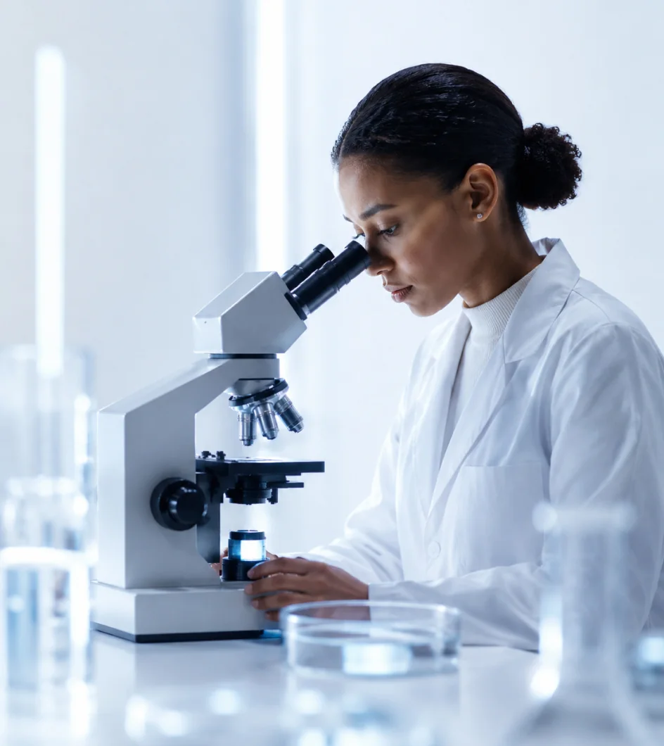 Researcher working at a microscope